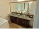 Bathroom with double vanity, glass bowl sinks, granite countertops and soaking tub reflected in mirror at 4590 River Stone Trl, Douglasville, GA 30135