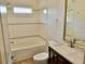 Bright bathroom featuring a shower-over-tub combination with stylish tile accents and a modern vanity with dark cabinets at 4590 River Stone Trl, Douglasville, GA 30135