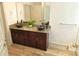 Bathroom with double vanity, vessel sinks, granite countertops, tile backsplash, and wood-look flooring at 4590 River Stone Trl, Douglasville, GA 30135