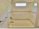 Bathroom featuring a tiled shower/tub with neutral walls and new fixtures at 4590 River Stone Trl, Douglasville, GA 30135
