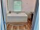 Bathroom with a jetted soaking tub and large window at 4590 River Stone Trl, Douglasville, GA 30135