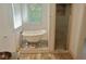 Elegant bathroom with a clawfoot tub, a separate glass-enclosed shower, and stylish fixtures at 4590 River Stone Trl, Douglasville, GA 30135