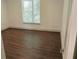 Bedroom with dark wood flooring and large window offering abundant natural light at 4590 River Stone Trl, Douglasville, GA 30135