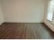 Bright bedroom with wood-look floors and natural light from the window at 4590 River Stone Trl, Douglasville, GA 30135