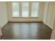 Bright bedroom features wood floors, three sunny windows, and a double-door closet at 4590 River Stone Trl, Douglasville, GA 30135