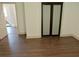 Bedroom featuring hardwood floors, neutral paint and large sliding-door closet at 4590 River Stone Trl, Douglasville, GA 30135