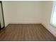 Bright bedroom with wood-look floors and natural light from the window at 4590 River Stone Trl, Douglasville, GA 30135