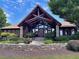 Striking clubhouse featuring exposed timber beams, stone columns, and professionally landscaped grounds at 4590 River Stone Trl, Douglasville, GA 30135