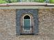 Exterior view of a window framed by a brick and stone archway at 4590 River Stone Trl, Douglasville, GA 30135