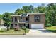 Charming two-story brick home with a manicured front yard and attached two-car garage at 4590 River Stone Trl, Douglasville, GA 30135