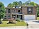 Lovely two-story brick home with a well-maintained lawn and an attached two-car garage at 4590 River Stone Trl, Douglasville, GA 30135