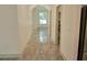 Bright hallway features lovely tiled floors and arched entry to the naturally lit living space at 4590 River Stone Trl, Douglasville, GA 30135