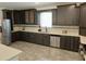 Elegant kitchen equipped with dark cabinets, stainless appliances, and a tiled backsplash at 4590 River Stone Trl, Douglasville, GA 30135