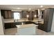 Well-equipped kitchen featuring dark cabinets, stainless steel appliances, and a center island at 4590 River Stone Trl, Douglasville, GA 30135