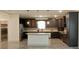 Spacious kitchen featuring dark wood cabinets, a center island, and stainless steel appliances at 4590 River Stone Trl, Douglasville, GA 30135