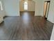 Living room with laminate wood flooring and large window providing natural light at 4590 River Stone Trl, Douglasville, GA 30135