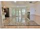 Spacious living room with gleaming marble floors, neutral walls, and French doors to the outside at 4590 River Stone Trl, Douglasville, GA 30135
