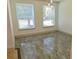 Bright living room with two windows and wood-look flooring at 4590 River Stone Trl, Douglasville, GA 30135