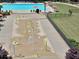 Aerial view of a community pool and splash pad with colorful water features at 4590 River Stone Trl, Douglasville, GA 30135