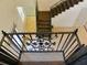 Elegant staircase with decorative iron railing and tile flooring leading to the upper level at 4590 River Stone Trl, Douglasville, GA 30135