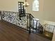 Elaborate ironwork staircase in a two-story foyer with hardwood flooring at 4590 River Stone Trl, Douglasville, GA 30135