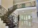 Elegant staircase featuring stone steps, an ornate metal banister and an open floorplan at 4590 River Stone Trl, Douglasville, GA 30135