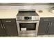 Stainless steel stove with cooktop and oven set in modern kitchen with tiled backsplash at 4590 River Stone Trl, Douglasville, GA 30135