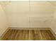 Walk-in closet with wood-look flooring and adjustable white wire shelving at 4590 River Stone Trl, Douglasville, GA 30135