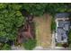 Aerial view of a home with a large, private yard surrounded by lush greenery and neighboring houses at 1052 Curran Nw St, Atlanta, GA 30318