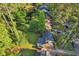 Aerial view showcasing a home with a well-maintained lawn, mature trees, and driveway at 1521 Deerwood Dr, Decatur, GA 30030