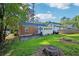 Large backyard with green lawn, tall trees, and a patio area connecting to the house at 1521 Deerwood Dr, Decatur, GA 30030
