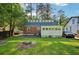 Spacious backyard featuring a well-maintained lawn, mature trees, and a patio area perfect for entertaining at 1521 Deerwood Dr, Decatur, GA 30030