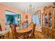 Bright dining room featuring a wooden table, chandelier, vintage furnishings, and peach colored walls creating a classic ambiance at 1521 Deerwood Dr, Decatur, GA 30030
