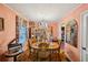 Elegant dining room with vintage furniture, chandelier, and unique peach colored walls creating a classic ambiance at 1521 Deerwood Dr, Decatur, GA 30030