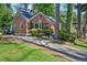 Charming brick home featuring a cozy front porch and well-manicured landscaping at 1521 Deerwood Dr, Decatur, GA 30030
