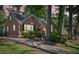 Charming home with a brick facade, well-manicured lawn, and beautiful trees at 1521 Deerwood Dr, Decatur, GA 30030