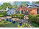 Beautiful brick home with a landscaped front yard and vibrant blue potted plants on a well-maintained lawn at 1521 Deerwood Dr, Decatur, GA 30030