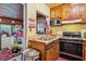Classic kitchen with dark cabinets, stainless steel appliances, and a connecting window to the next room at 1521 Deerwood Dr, Decatur, GA 30030