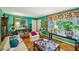 Cozy living room featuring vintage furniture, a large window, and unique turquoise walls for a touch of charm at 1521 Deerwood Dr, Decatur, GA 30030