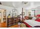 Spacious bedroom featuring hardwood floors, chandelier, and large dresser with ornate mirror at 1521 Deerwood Dr, Decatur, GA 30030