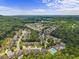 Overhead shot of a community with a pool and tennis courts nestled among trees, with mountain views in the distance at 1850 Overlook Springs Ln, Cumming, GA 30040