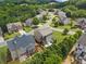 Residential neighborhood with two-story homes surrounded by lush green trees and lawns at 1850 Overlook Springs Ln, Cumming, GA 30040