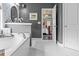 Bathroom showcasing a soaking tub, white marble floors, and a view into the adjacent bedroom at 1850 Overlook Springs Ln, Cumming, GA 30040