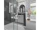Bathroom with a glass shower enclosure, soaking tub, and stylish fixtures under well-placed lighting at 1850 Overlook Springs Ln, Cumming, GA 30040