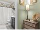 Charming bathroom featuring floral wallpaper, black vanity, and shower with white curtain at 1850 Overlook Springs Ln, Cumming, GA 30040