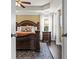 Bedroom featuring an ornate dark wood bed frame with natural light streaming through white curtains at 1850 Overlook Springs Ln, Cumming, GA 30040