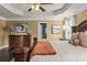 Bedroom showcasing tray ceilings, crown molding, a ceiling fan, and a traditional dark wood dresser at 1850 Overlook Springs Ln, Cumming, GA 30040
