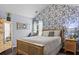 Bedroom with natural wood furniture and wallpaper at 1850 Overlook Springs Ln, Cumming, GA 30040