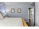 Cozy bedroom featuring a blue accent wall, neutral paint, and hardwood floors leading to the hallway at 1850 Overlook Springs Ln, Cumming, GA 30040