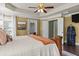 Spacious bedroom with tray ceilings, a ceiling fan, a door to the backyard, and natural light at 1850 Overlook Springs Ln, Cumming, GA 30040